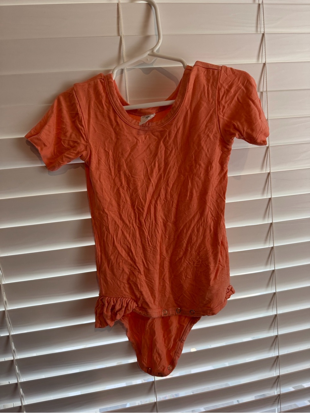 Kate Quinn Coral Short-Sleeve One-Piece Bodysuit with ruffle side detail